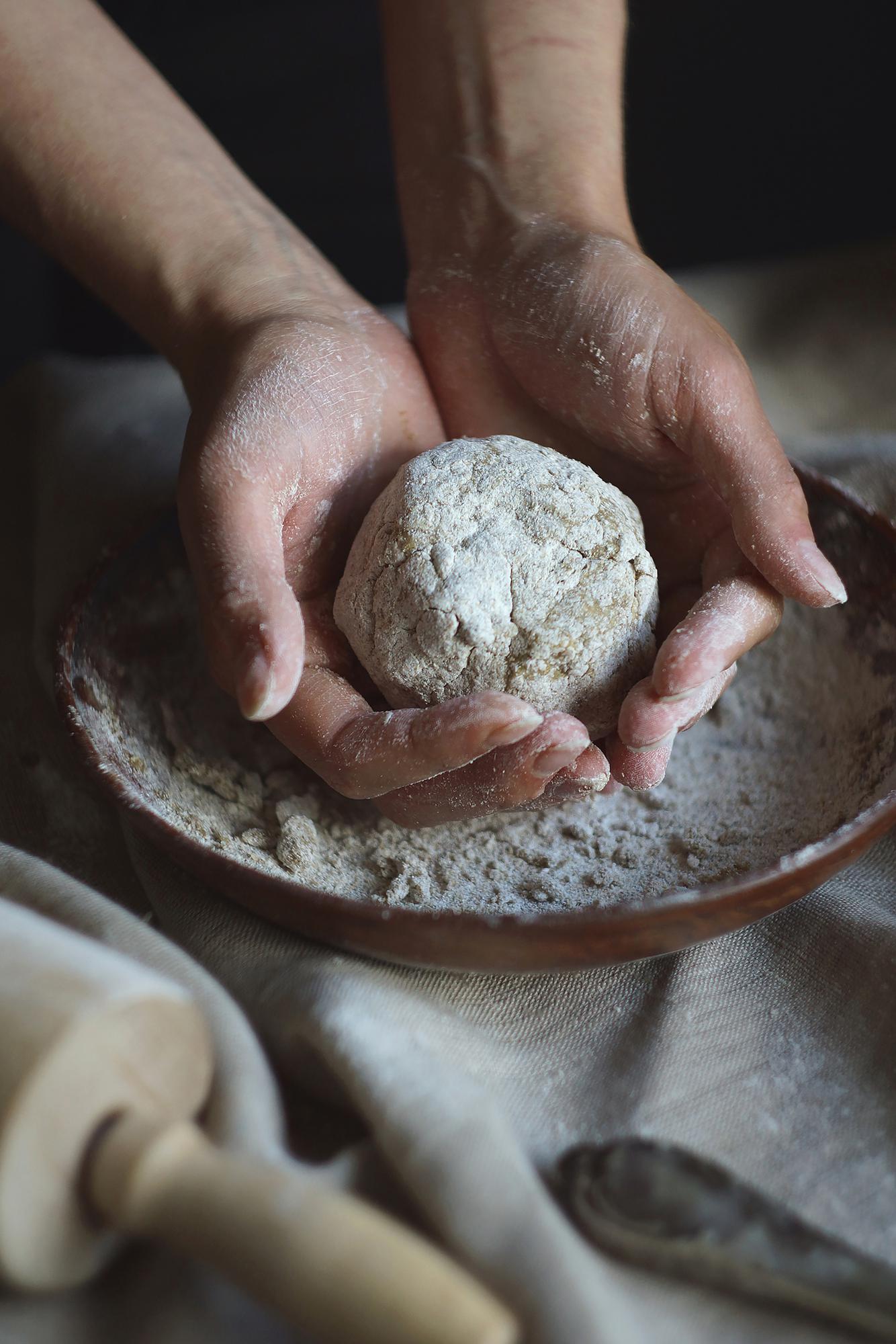 Close-up of hands kneading dough